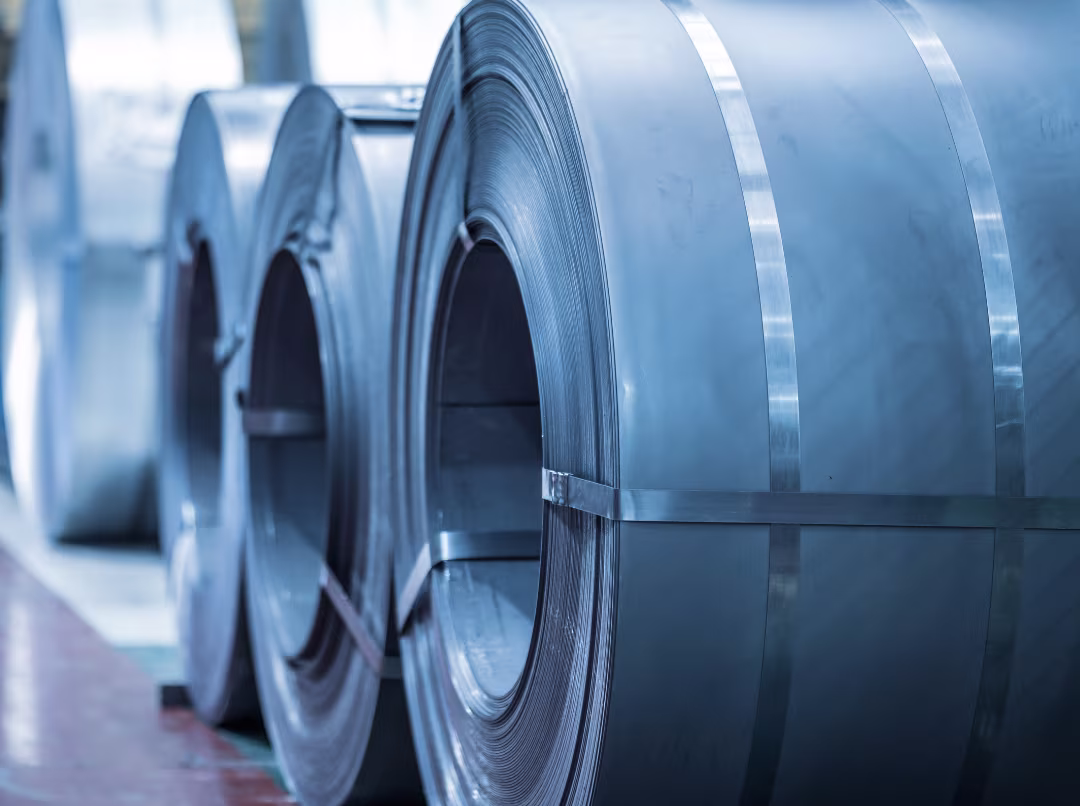 Steel coils stacked in industrial warehouse