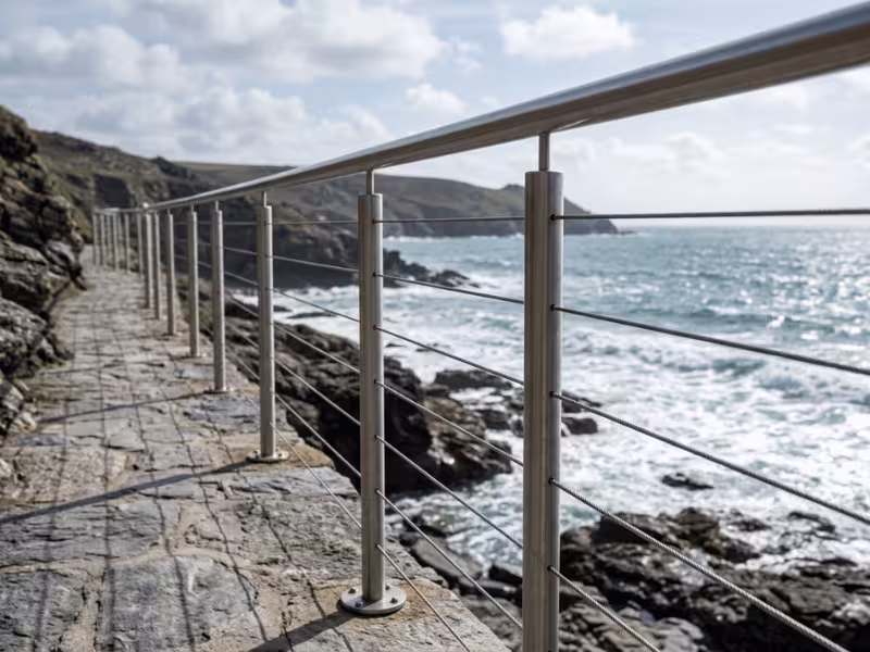 Stainless steel railing beside a coastal walkway Stainless steel railing beside a coastal walkway